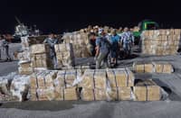 Authorities inspect the smuggled cigarettes that were intercepted at the Port of Dumaguete City in Negros Oriental.