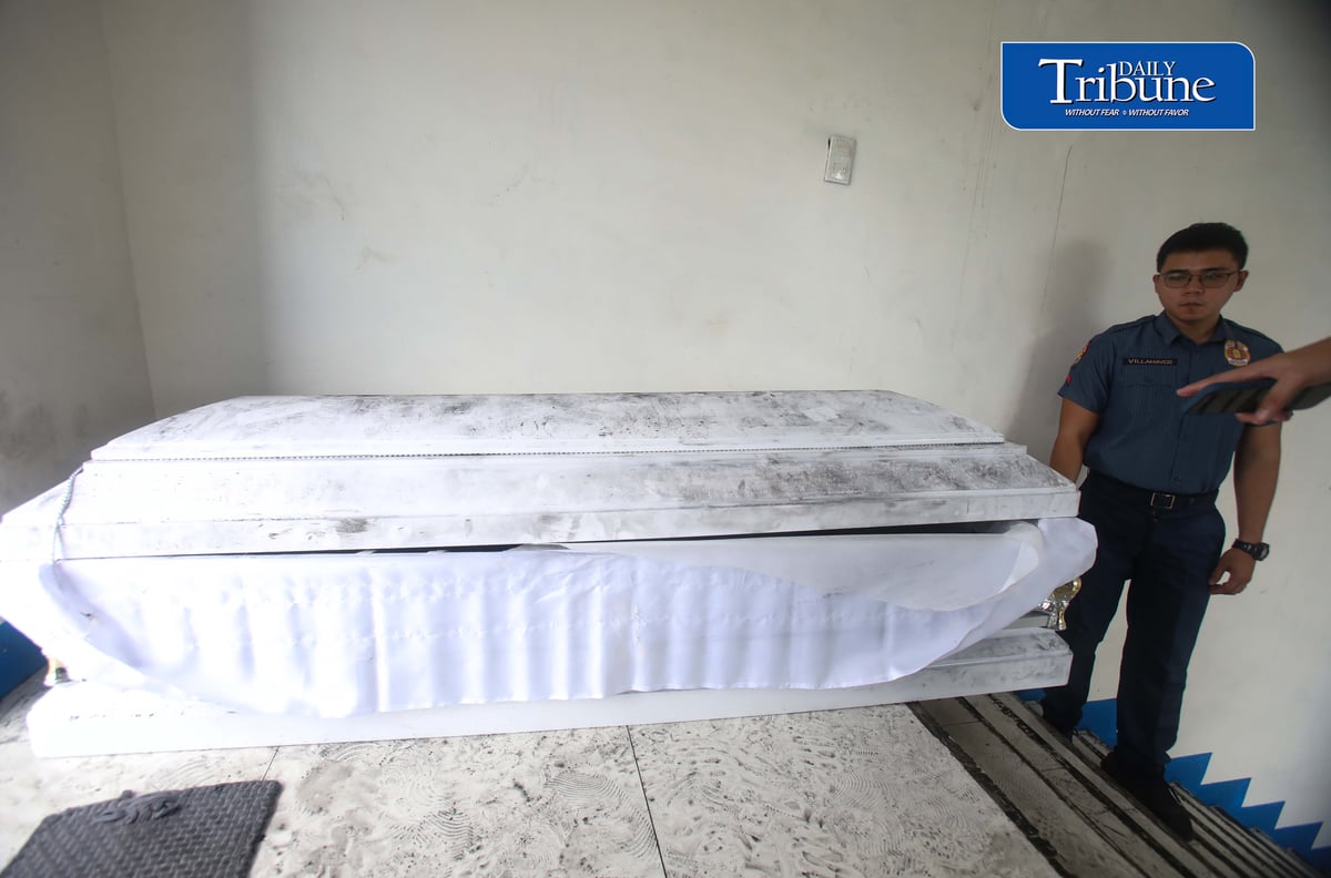 (August 07 2026) QCPD Police personnel at the Kamuning Police Station 10 in Quezon on Friday August 7 2026, stand guard at the one of the two abandoned coffin with banners and crumpled papers inside were discovered, found at the Boy Scout Circle (Barangay South Triangle) and the Welcome Rotonda (Barangay Sta. Teresita), They were part of a coordinated series of five caskets dumped across Metro Manila carrying anti-China and anti-communist messages. Photo/Analy Labor