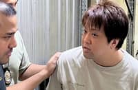 Bureau of Immigration agents process Japanese fugitive Koizumi Haruki following his arrest inside the agency’s headquarters in Intramuros, Manila, while attempting to apply for a visa extension.