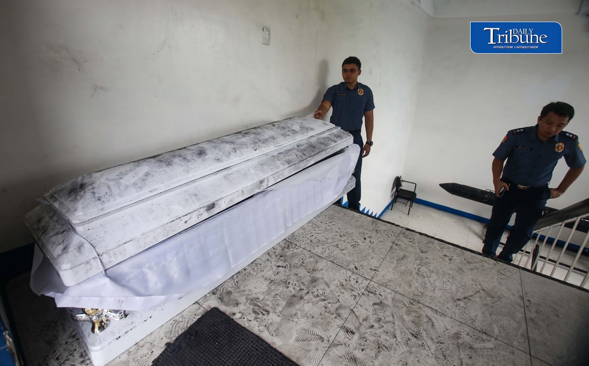 (August 07 2026) QCPD Police personnel at the Kamuning Police Station 10 in Quezon on Friday August 7 2026, stand guard at the one of the two abandoned coffin with banners and crumpled papers inside were discovered, found at the Boy Scout Circle (Barangay South Triangle) and the Welcome Rotonda (Barangay Sta. Teresita), They were part of a coordinated series of five caskets dumped across Metro Manila carrying anti-China and anti-communist messages. Photo/Analy Labor