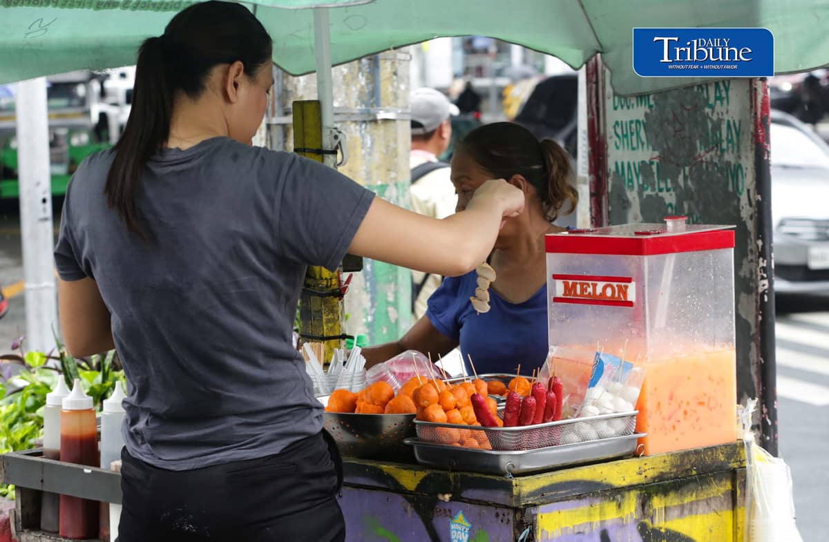 (August 07 2026) Customer buying street food such along Kamias corner Edsa in Quezon City on Friday August 7 2026.  Manila recently ranked No. 4 globally on Time Out’s 2026 list of the world's best cities for street food, praised for its incredible affordability and vibrant curbside culinary culture. Photo/Analy Labor
