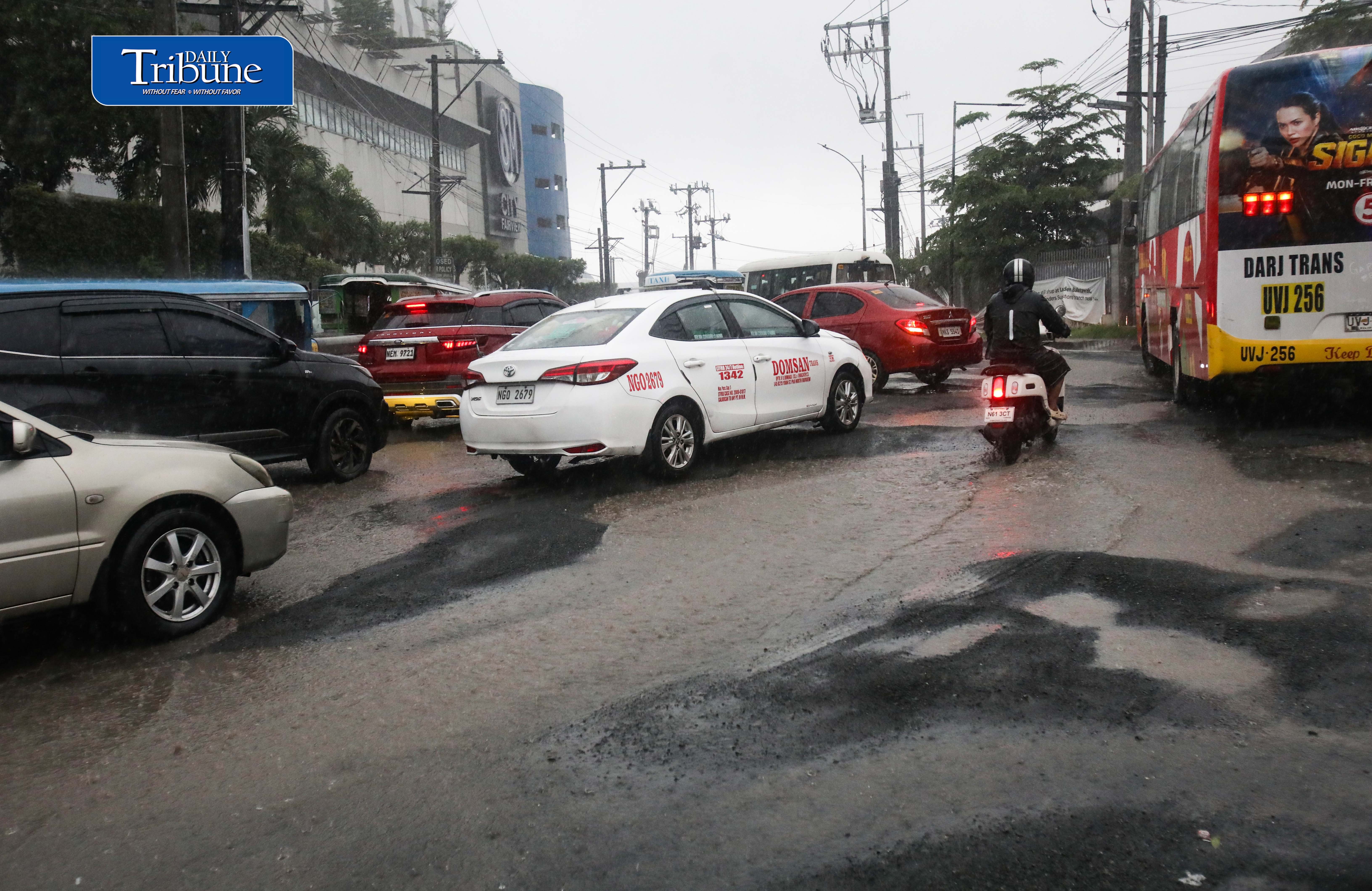 (August 08 2026) Motorists moving slowly due to the huge potholes along Belfast avenue corner Quirino highway in Novaliches, Quezon City, on Saturday August 8 2026. Photo/Analy Labor
