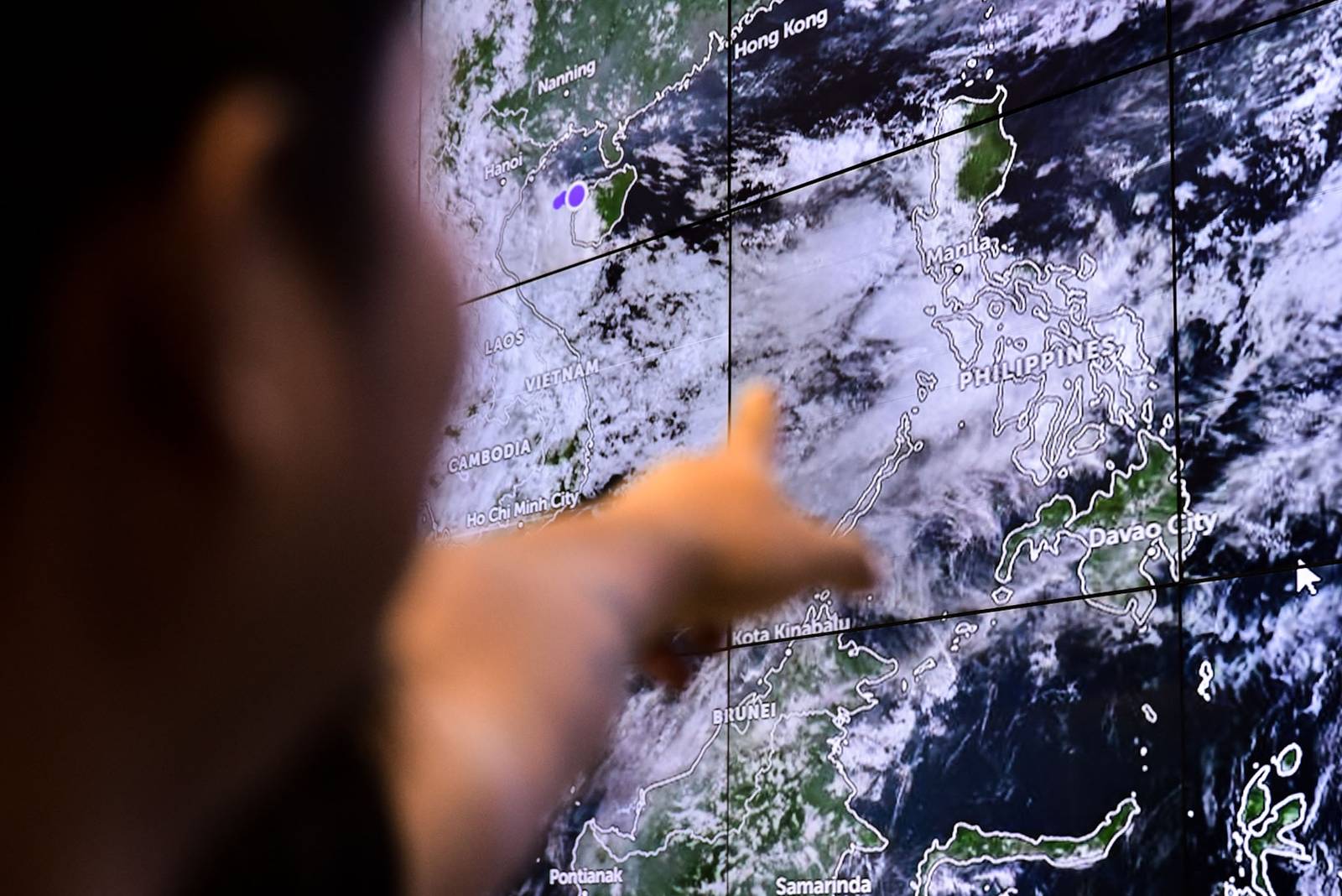 Personnel from the Manila City Disaster Risk Reduction and Management Department monitor flood-prone areas in Manila as the enhanced southwest monsoon brings heavy rains and flooding on August 8. | Zedrich Xylak Madrid