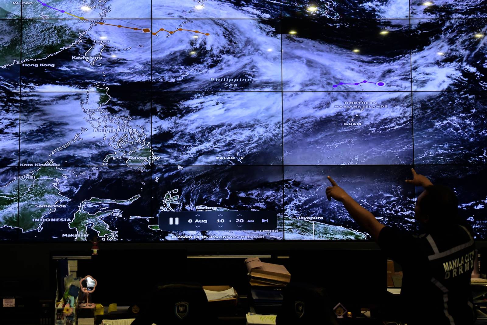 Personnel from the Manila City Disaster Risk Reduction and Management Department monitor flood-prone areas in Manila as the enhanced southwest monsoon brings heavy rains and flooding on August 8. | Zedrich Xylak Madrid