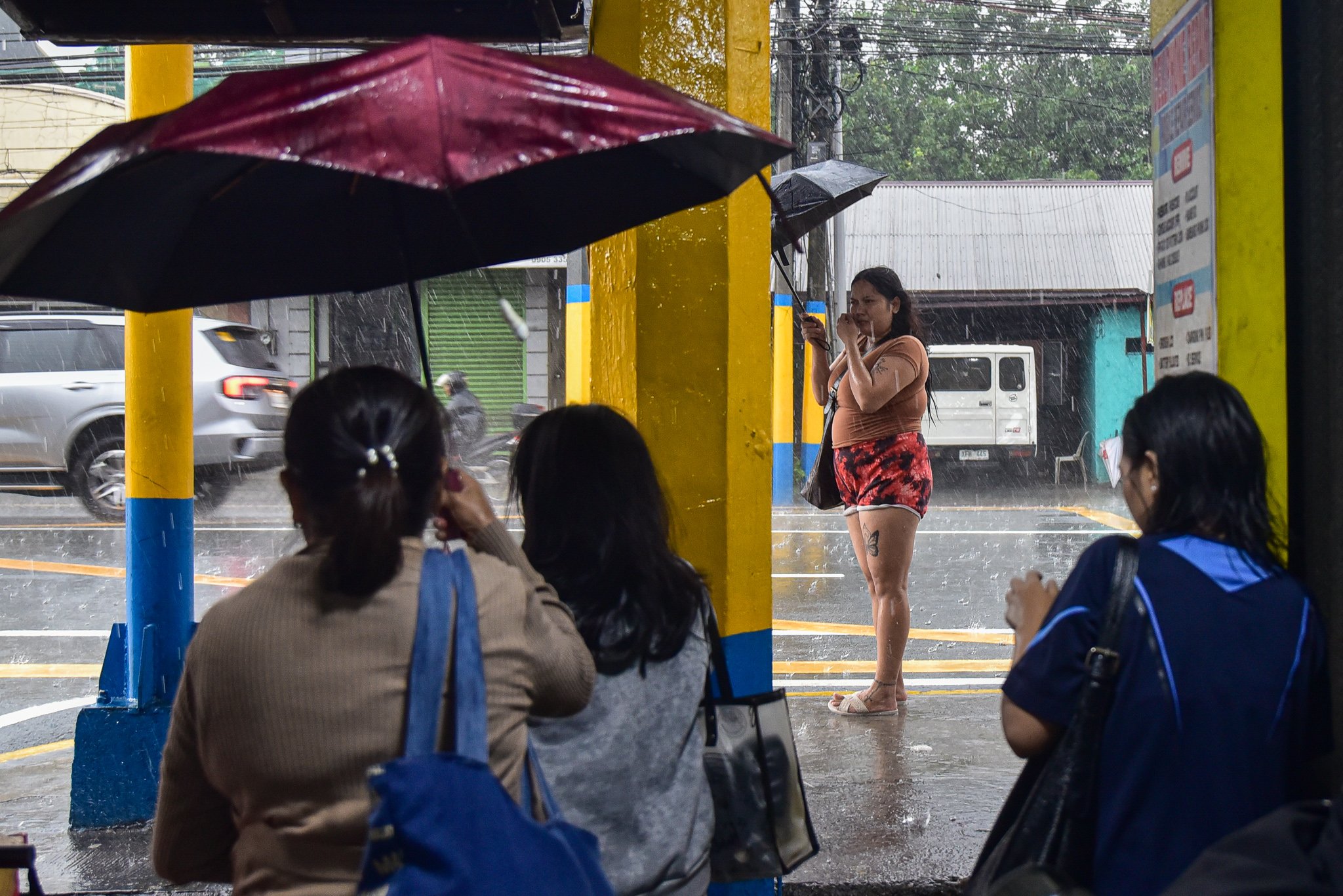 Residents brave heavy habagat rains along Emilio Aguinaldo Highway
