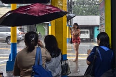 Residents brave heavy habagat rains along Emilio Aguinaldo Highway