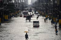 WHEN waters rise Habagat rains turn roads and sanctuaries into waterways across Luzon, forcing commuters to wade through flooded streets in Cavite (main photo), inundating communities in Nueva Ecija (top left panel) and leaving the Sto. Niño Parish in San Fernando, Pampanga, under ankle-deep water.