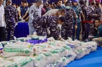 OFFICERS from various Indonesian agencies prepare sacks containing ketamine during a press conference revealing an international narcotics smuggling case in Batam, Riau Islands, on 9 August 2026.