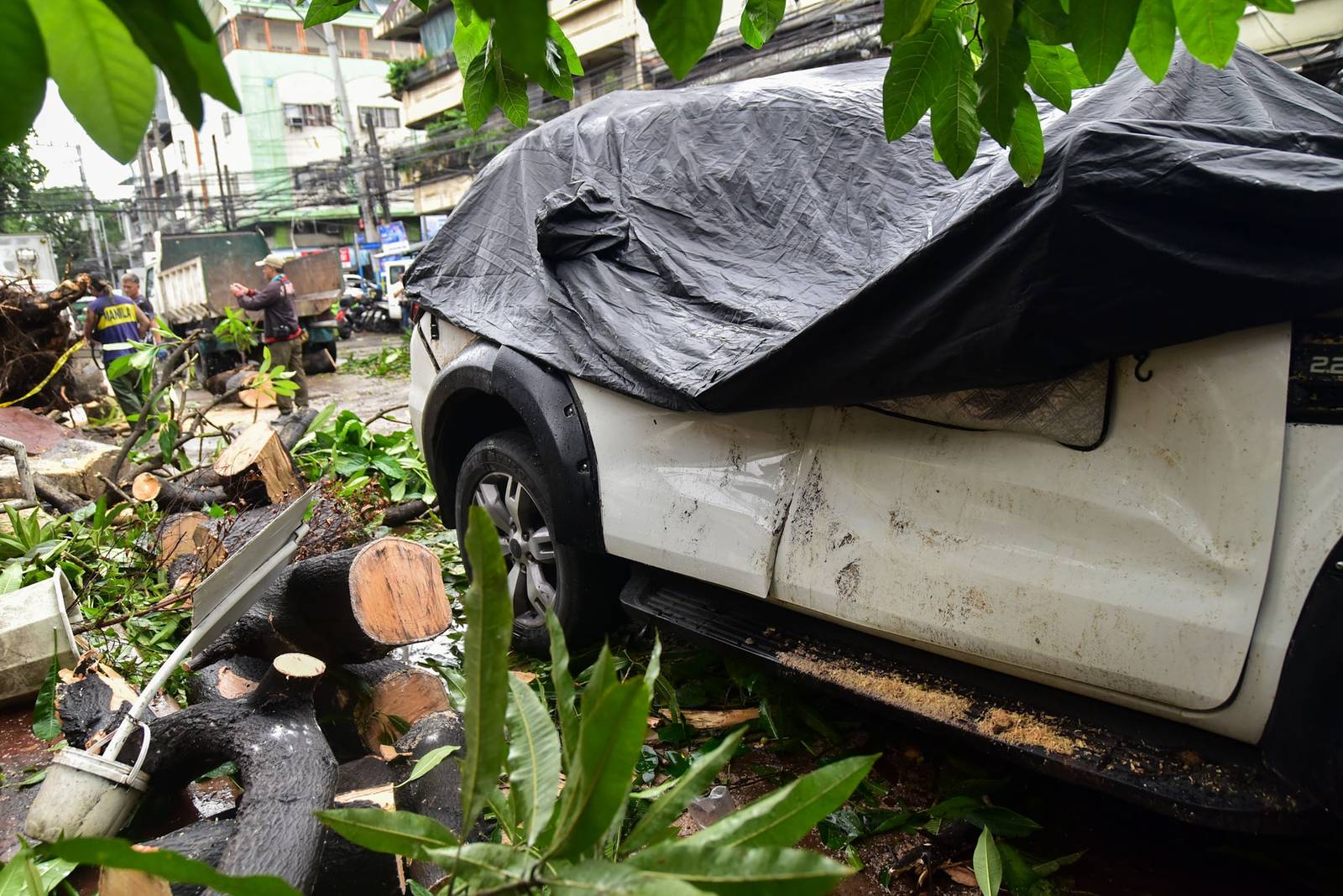 Personnel clear debris from a mango tree that fell onto an SUV along Malabon and Oroquieta streets in Sta. Cruz, Manila, on August 10.

Two houses also lost their roofs after a tornado struck Tayuman amid heavy rain and strong winds brought by the enhanced southwest monsoon (Habagat) l Zedrich Xylak Madrid