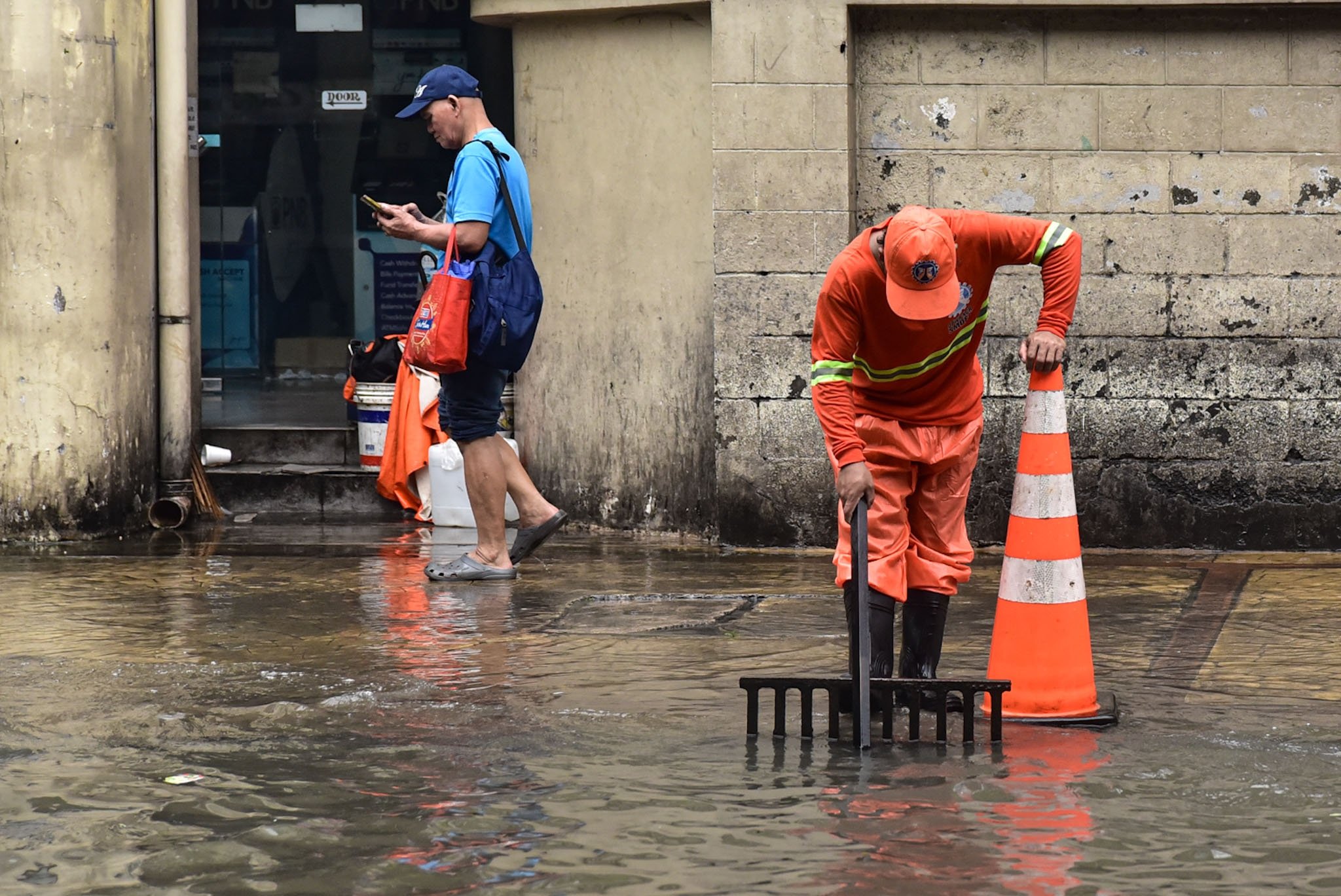 Workers clears clogged drainages along Taft Avenue