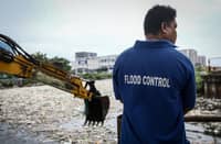 Personnel work through the rain to clear a massive buildup of garbage from the Redemptorist Water Channel in Parañaque City on Tuesday afternoon, 11 August. | Aram Lascano