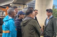 President Ferdinand Marcos Jr. talks to other government officials who accompanied him during the inspection of the reclaimed Manila Bay segment in Paranaque City on Tuesday.