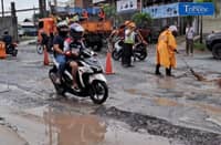 WORK IN PROGRESS. DPWH personnel repair a damaged section of Maysan Road in Valenzuela City on Wednesday, addressing potholes that have raised concerns among motorists. | Lisa Apacible