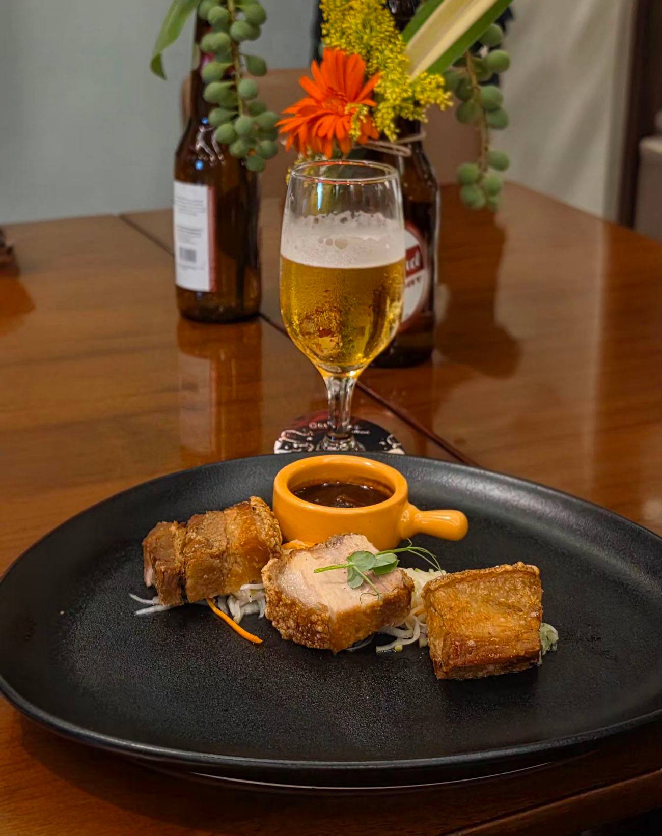 Crispy skin pork belly with apple daikon slaw paired with San Miguel Super Dry.