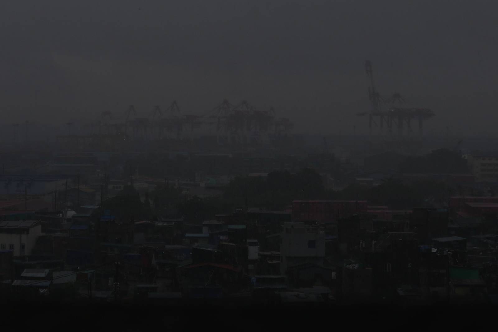 Heavy rain brought by the southwest monsoon, or habagat, reduces visibility over the port area in Manila on 14 August 2026, as seen from the Joaquin Domagoso Gymnasium. The state weather bureau PAGASA issued an Orange Rainfall Warning at 10:20 a.m.