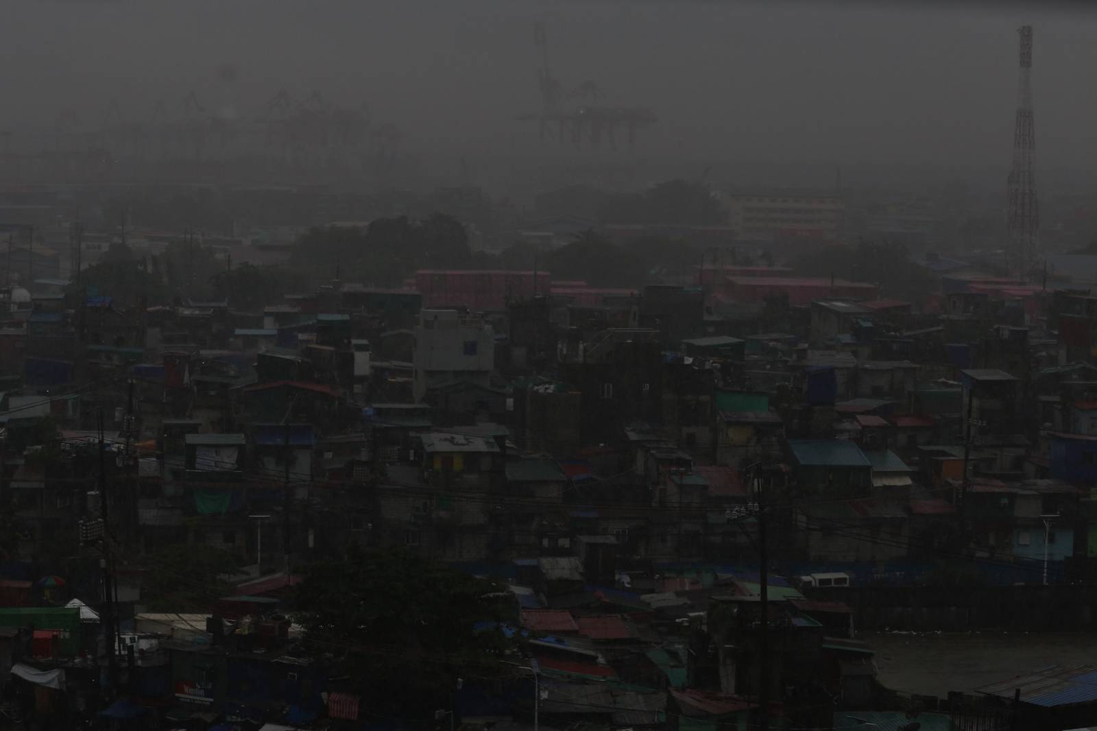 Heavy rain brought by the southwest monsoon, or habagat, reduces visibility over the port area in Manila on 14 August 2026, as seen from the Joaquin Domagoso Gymnasium. The state weather bureau PAGASA issued an Orange Rainfall Warning at 10:20 a.m.