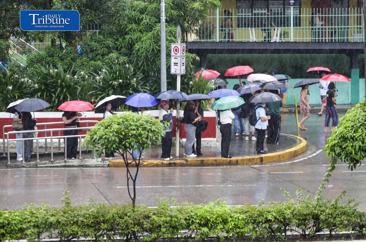 (August 14 2026) Students from Quezon City University, Batasan High school and Corazon Aquino elementary schools in Quezon City, use their umbrellas as they brave the rain on their way home after classes were suspended due to continuous rains brought by enhanced southwest monsoon on Friday, August 14, 2026. PAGASA said the rainy weather may persist into next week as a low pressure area could form inside the Philippine area of responsibility between Sunday and early next week, potentially enhancing the southwest monsoon. Photo/Analy Labor