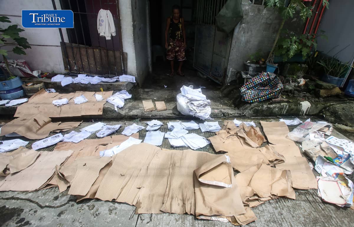 (August 15 2026) A man was seen spreading wet paper and boxes for drying outside his house in Caloocan City, to take advantage when the sun appeared, on Saturday morning August 15 2026. Photo/Analy Labor