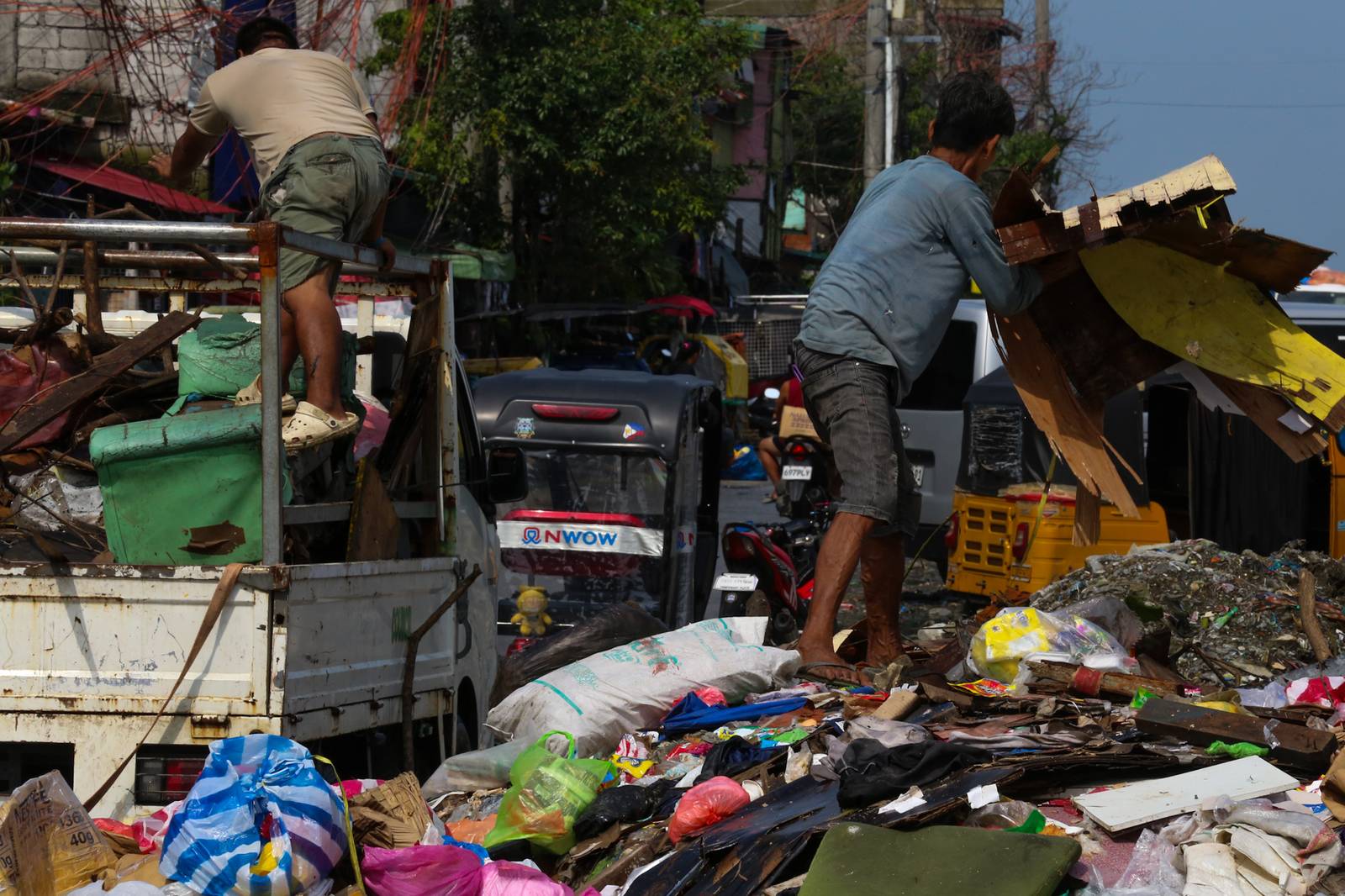 Barangay personnel collect trash and debris dumped along a seawall in Baseco, Manila, on 15 August 2026. According to the DENR, the Philippines generates up to 65,000 tons of waste daily, with nearly half going uncollected and contributing to pollution in streets and waterways.