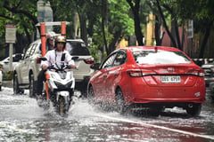 Wading through Manila floods