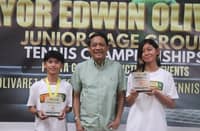 FRANCINE Wong (right) celebrates another double-title win alongside Jan Caleb Villeno (left) and Parañaque Youth and Sports Development head Alex Dandan in the Mayor Edwin Olivarez Juniors Age Group Tennis Championships last Thursday.