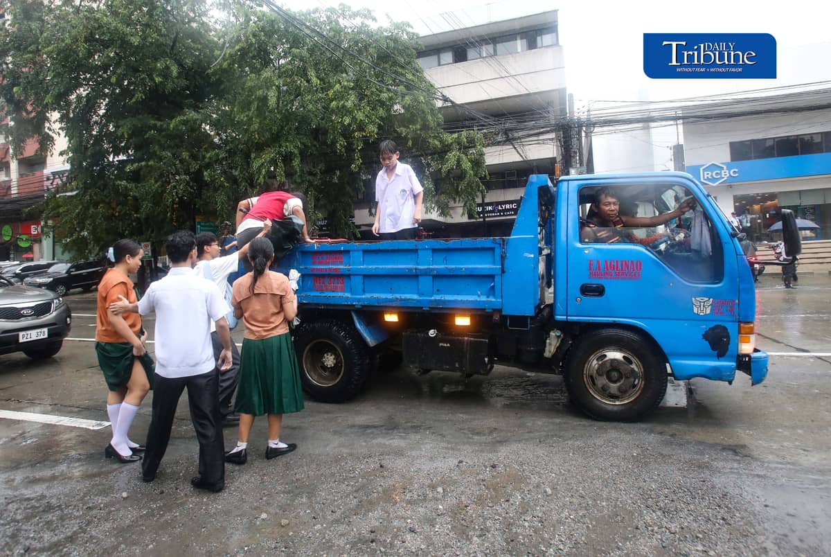 (August 17 2026) Students climb at the back of the truck to ride, when the driver offer them to ride to cross the flooded area along Timog in Quezon City, on Monday August 17 2026. Photo/Analy Labor