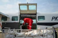 Personnel from Indonesia’s National Disaster Management Agency load sodium chloride into an aircraft before a cloud-seeding mission at Tjilik Riwut Airport in Palangka Raya, Central Kalimantan.