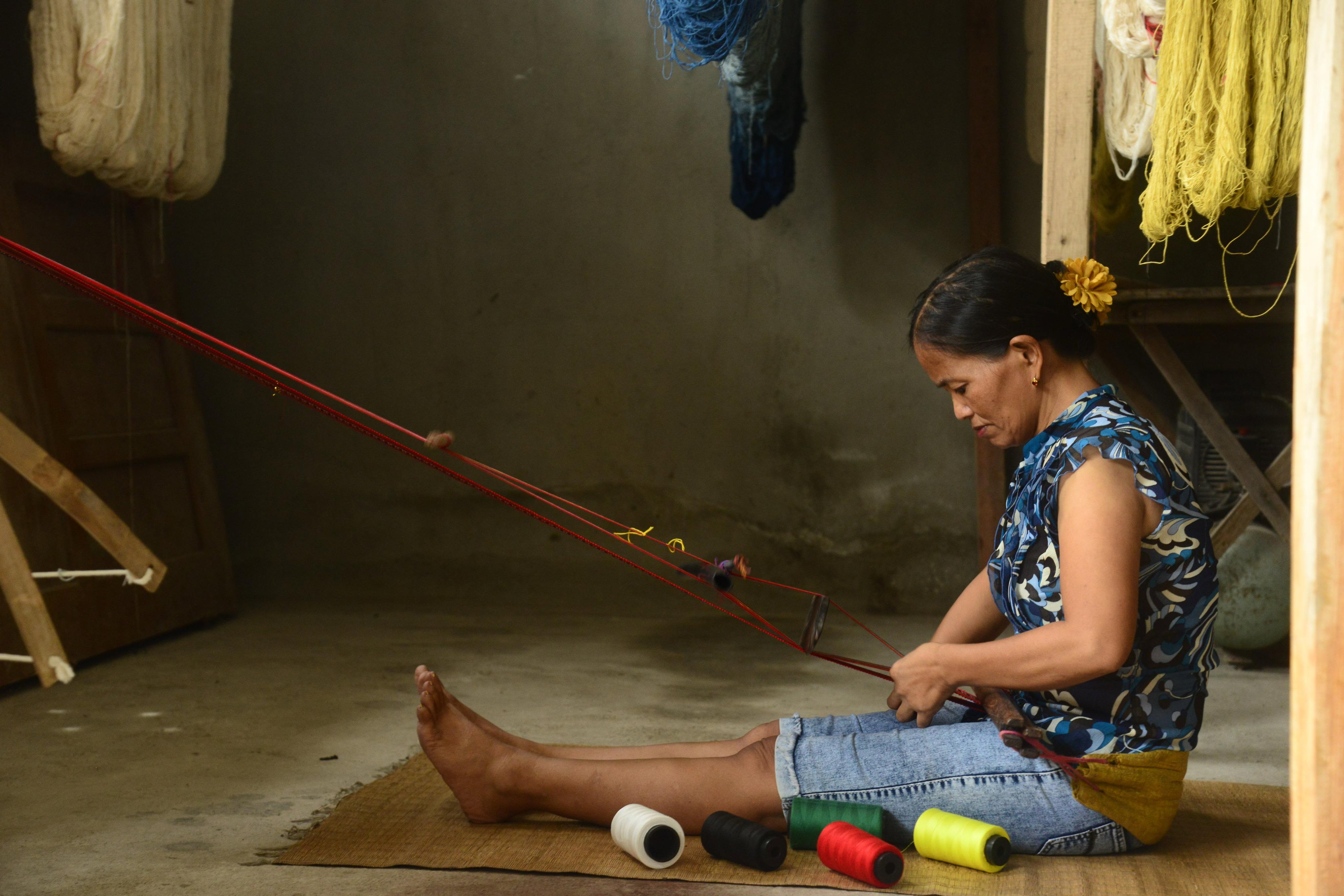Odess Biyao, 49-year-old KINWA weaver on the backstrap loom — an ancient weaving method that allowed the indigenous to transport their craft across the Cordillera mountains.