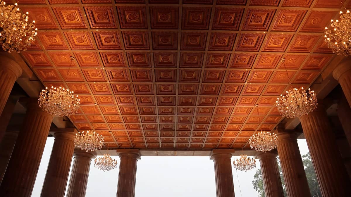 Grand coffered ceiling and neo-classical Doric columns adorned with crystal chandeliers in the lobby of the Temple of Leah.