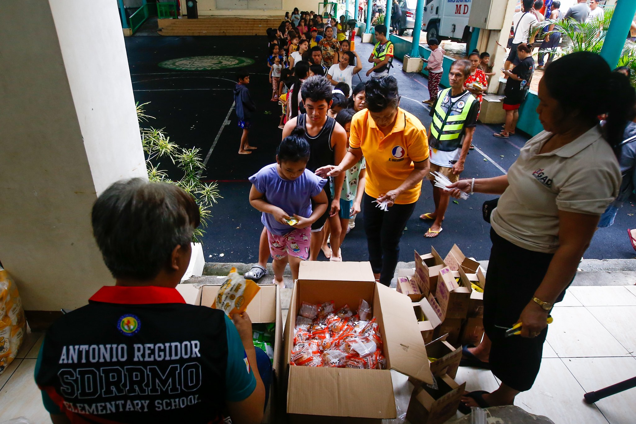 Flood evacuees line up for food