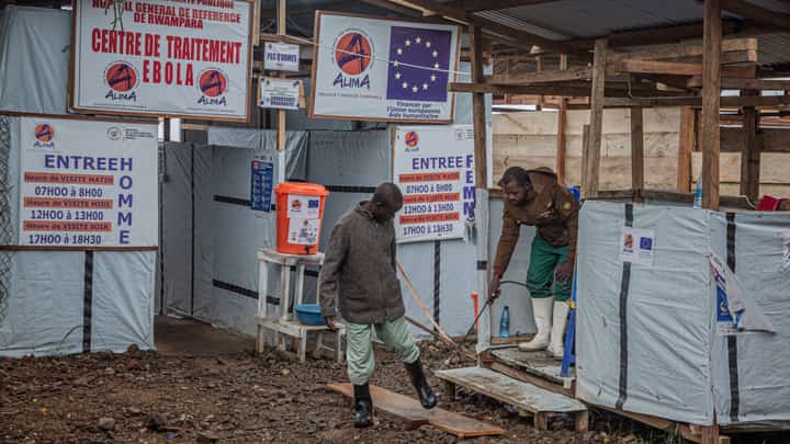 A hygiene worker disinfects a person's feet at the entrance to the Rwampara Ebola Treatment Centre (ETC) in Bunia, Ituri, in the east of the Democratic Republic of Congo on July 13, 2026. The Ebola outbreak raging in the Democratic Republic of Congo is growing "exponentially", the United Nations' senior Ebola coordinator warned on August 21, 2026. The Ebola outbreak is already the biggest in the country's history having killed more than 2,300 people from more than 5,000 cases, according to the African Union health agency. The virus eruption is "growing exponentially," United Nations' senior Ebola coordinator told reporters in Geneva, speaking from Bunia, in DRC.