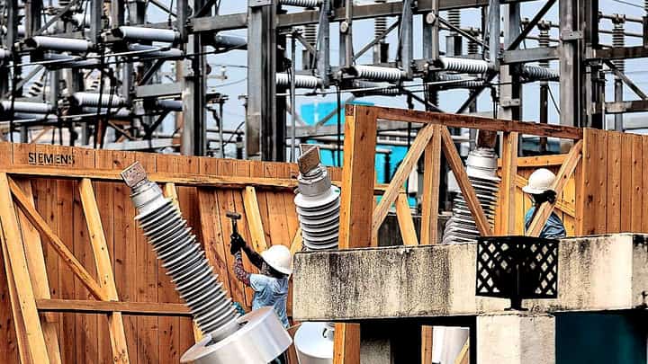 WORKERS uncrate a newly arrived high-voltage circuit breaker at a Meralco substation in Paco, Manila. The distribution utility is urging electric cooperatives to consider converting into stock corporations to open the door to private capital for upgrading and modernizing their systems. Meralco has said such investments could help address aging infrastructure and improve power distribution services.