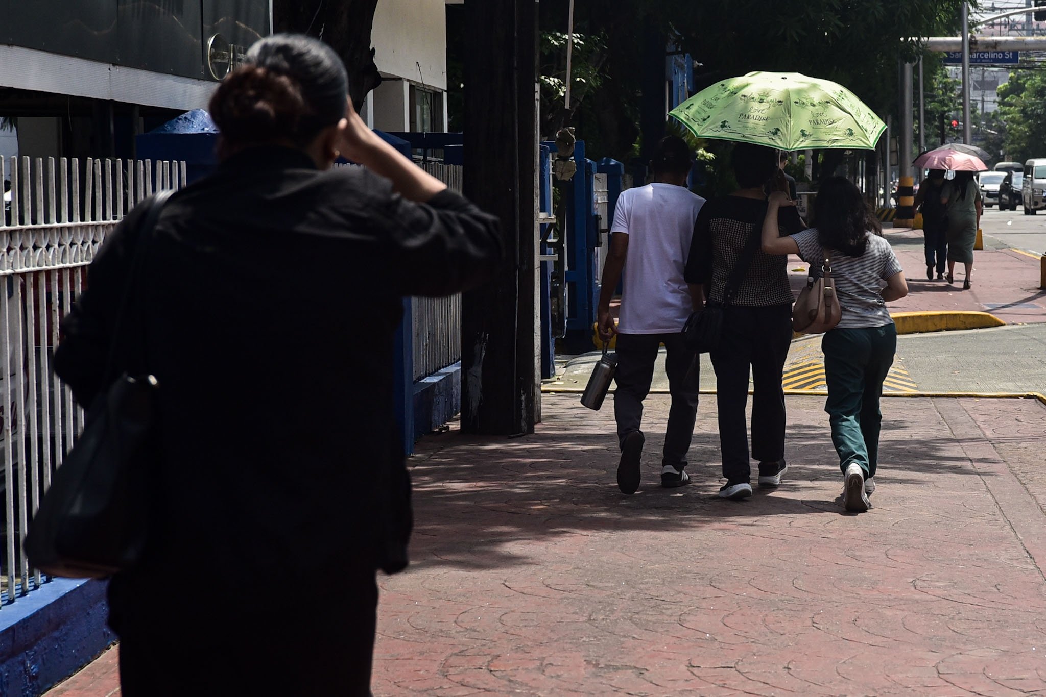 Pedestrians under the sun in Manila 