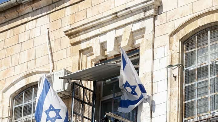 EVERYDAY life in Jerusalem’s Old City unfolds beneath Israeli flags and weathered stone walls.
