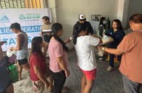 VOLUNTEERS distribute rice packs donated by Prime Infra Foundation and Prime Waste Solutions Pampanga to victims of habagat across host communities in Pampanga.