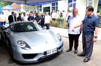 LAND Transportation Office Assistant Secretary Markus Lacanilao (second from right) and Bureau of Customs Commissioner Ariel Nepomuceno (right) inspect a surrendered high-end sports car — allegedly owned by a celebrity — at the LTO Central Office in Quezon City on Monday. The joint inspection follows investigations into the vehicle’s fake license plates, customs misdeclaration and tax underpayment.