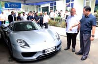 Land Transportation Office chief Markus Lacanilao and Bureau of Customs Commissioner Ariel Nepomuceno inspect a surrendered Porsche 918 Spyder at the LTO Central Office in Quezon City on 24 August.