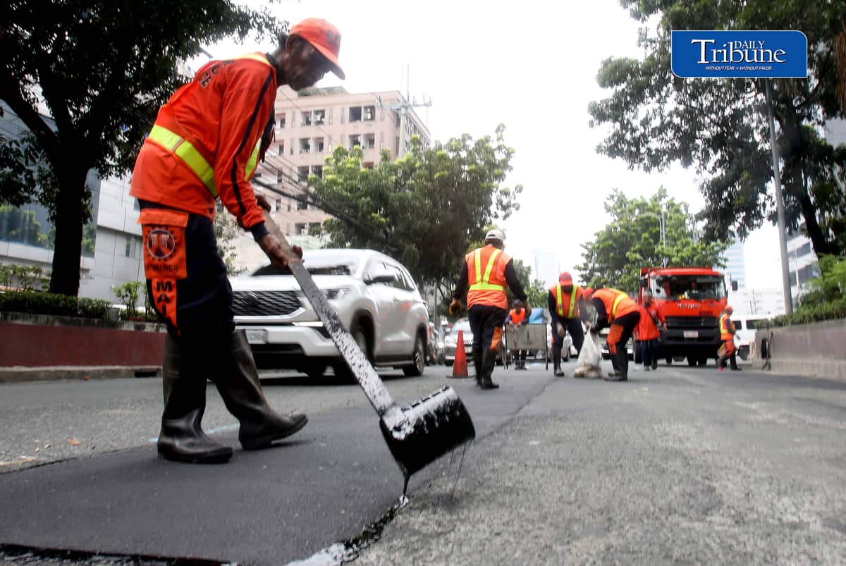 PATCHING UP QUEZON AVENUE
Department of Public Works and Highways workers take advantage of fair weather to repair and asphalt potholes along Quezon Avenue in Quezon City on Monday, 24 August.
📷 Analy Labor/DAILY TRIBUNE