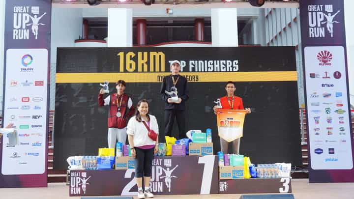 ROY Laudit (middle) celebrates on the podium after ruling the men’s 16K event of The Great UP Run on Sunday at the UP Diliman Grounds. Also shown are winners Joel Orogan and Mark Anthony Oximar.