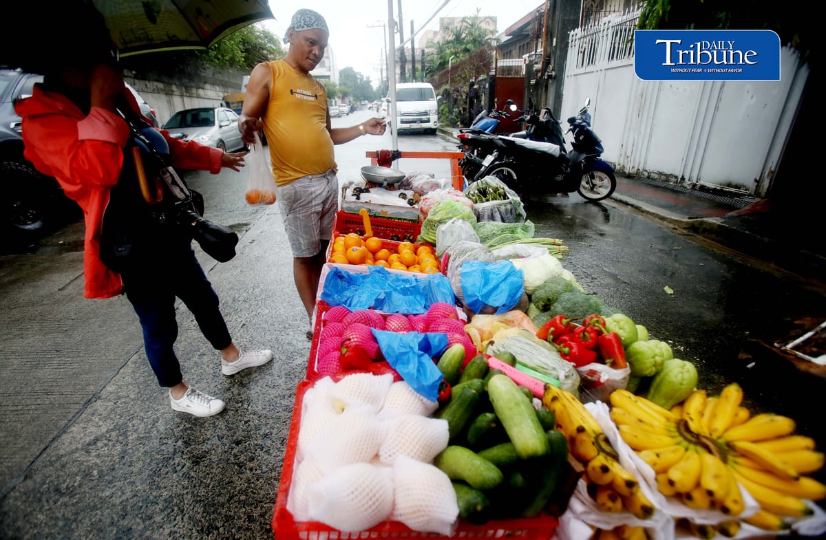 (August 28 2026) Heavy rain is not deferred to a fruit and vegetables vendor to go selling his products in Quezon City on Friday August 28 2026, to earn money to spend on everyday expenses for his family. Photo/Analy Labor