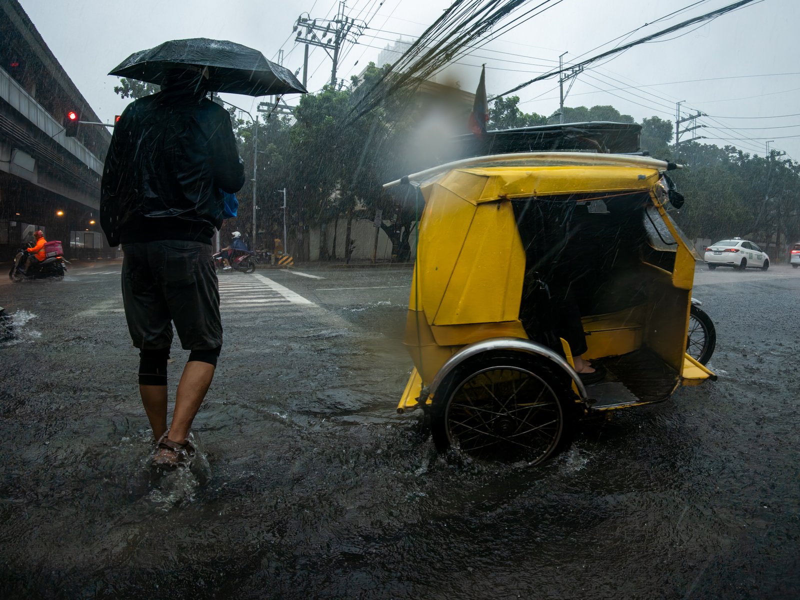 Floodwaters cover a road at the corner of Taft Avenue and UN Avenue in Manila on 29 August 2026, as heavy rains brought by the southwest monsoon, or habagat, inundated parts of the capital. PAGASA issued a Red Rainfall Warning for Metro Manila, warning of serious flooding in low-lying and flood-prone areas.
