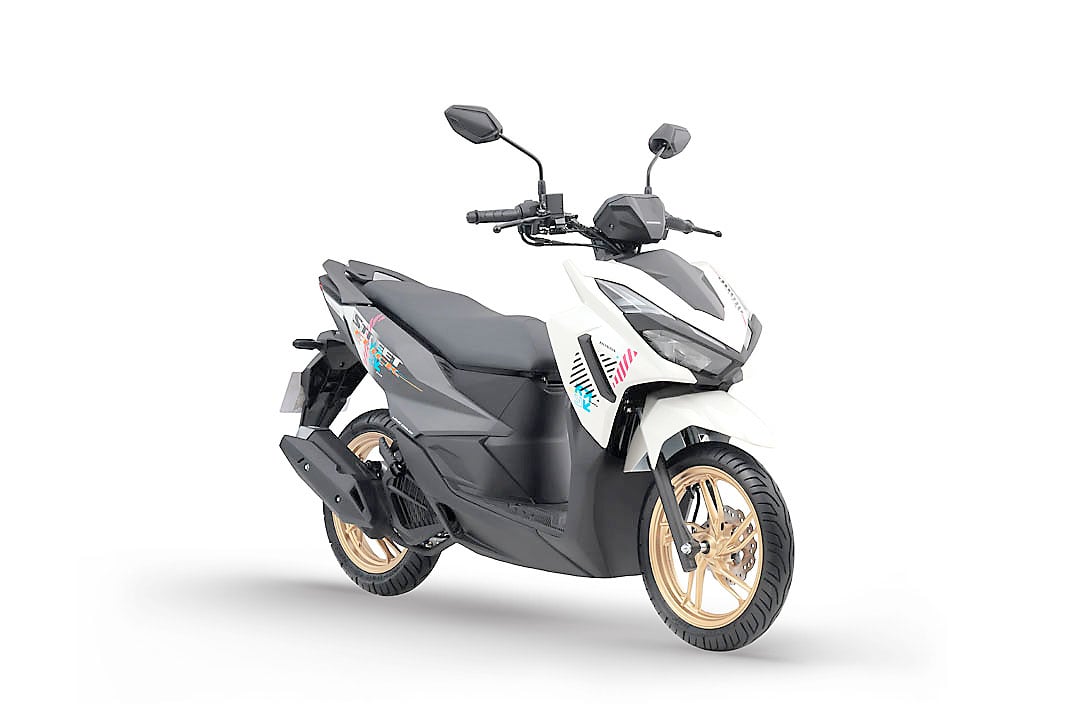 PROFILED in Pearl Arctic White, the Honda Click125 Street pairs white bodywork with gold wheels and colorful graphics.