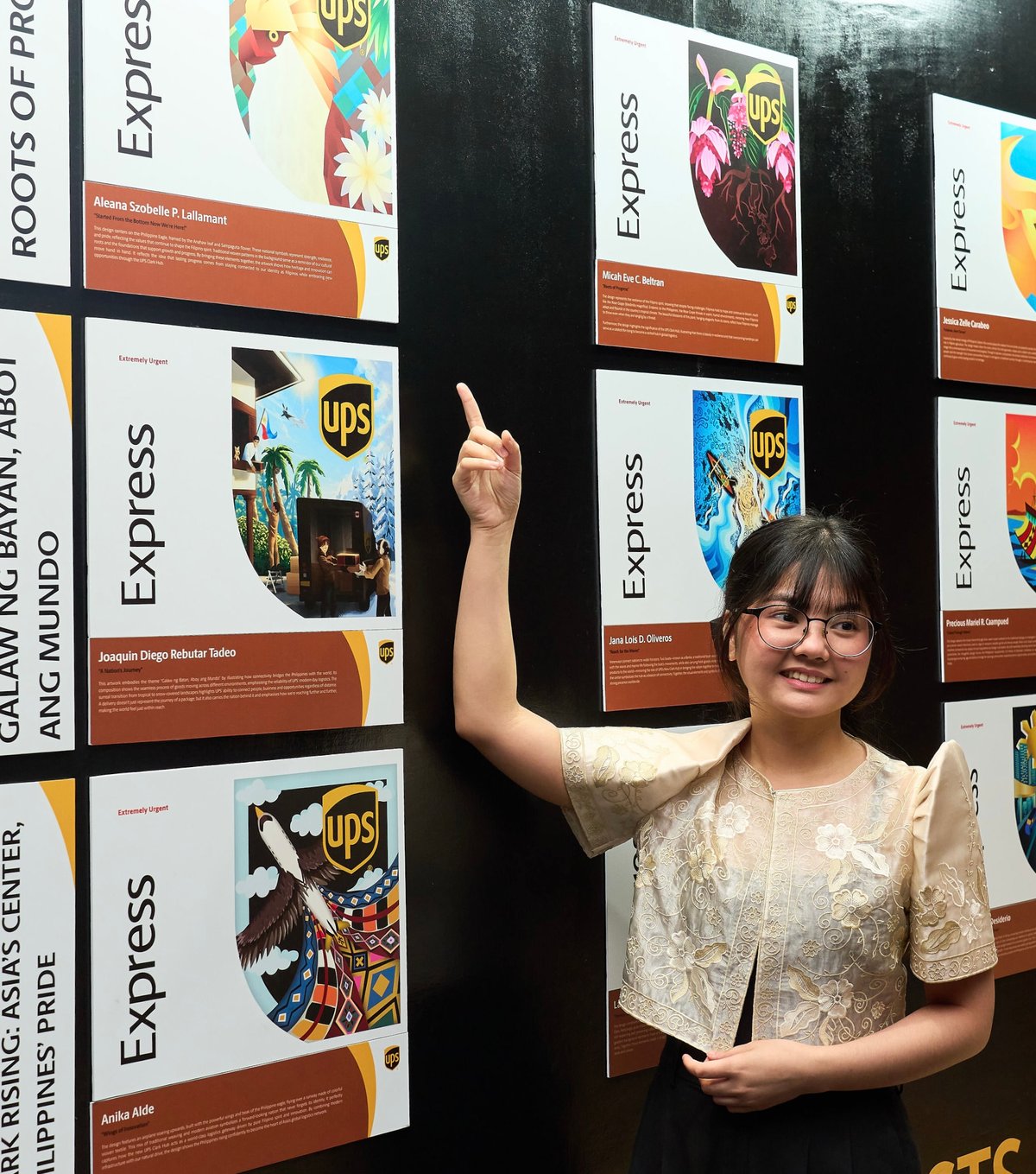 Roots of Progress theme winner Aleana Szobelle P. Lallamant posing alongside her exhibited work.