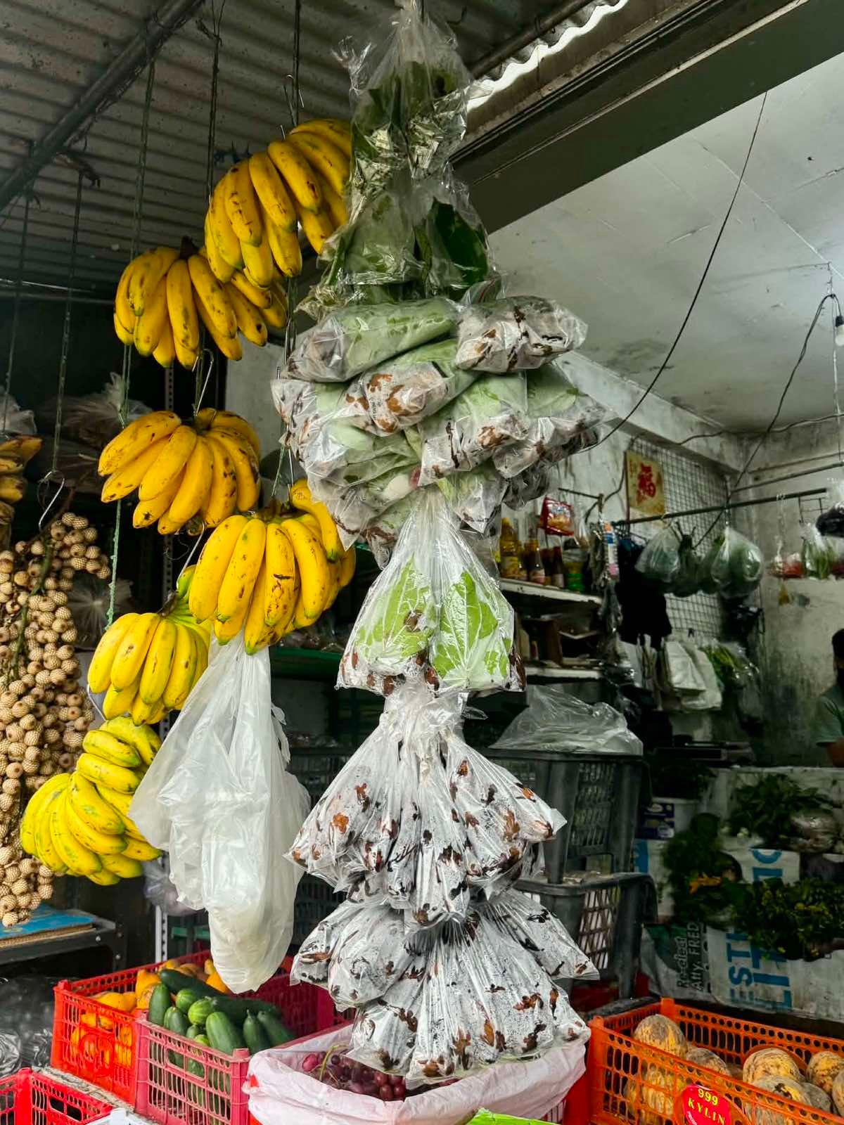 A SARI-SARI store in Baguio City sells nga-nga, with packets of betel leaves and other ingredients displayed alongside fruits and vegetables.