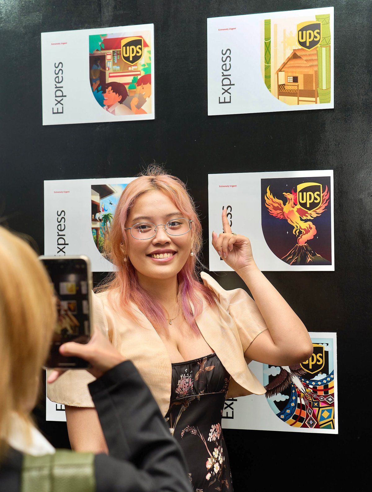 Gracielle Margaret Rigor, top 10 finalist, posing with her exhibited artwork.