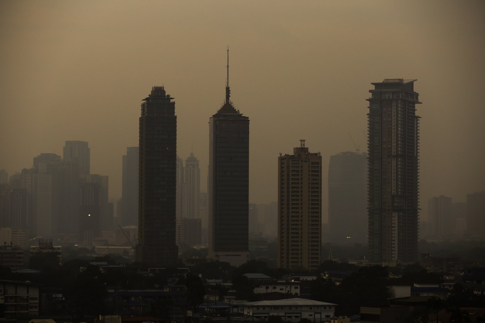 A thick haze blankets the Metro Manila skyline at 6:01am on 01 September 2026 as smoke from wildfires in Kalimantan is carried toward the Philippines by cross-equatorial winds. Air quality monitoring sensors across Metro Manila recorded AQI levels ranging from Unhealthy for Sensitive Groups to Very Unhealthy. Local government units, including Quezon City, have suspended face-to-face classes at all levels in public schools amid the poor air quality.