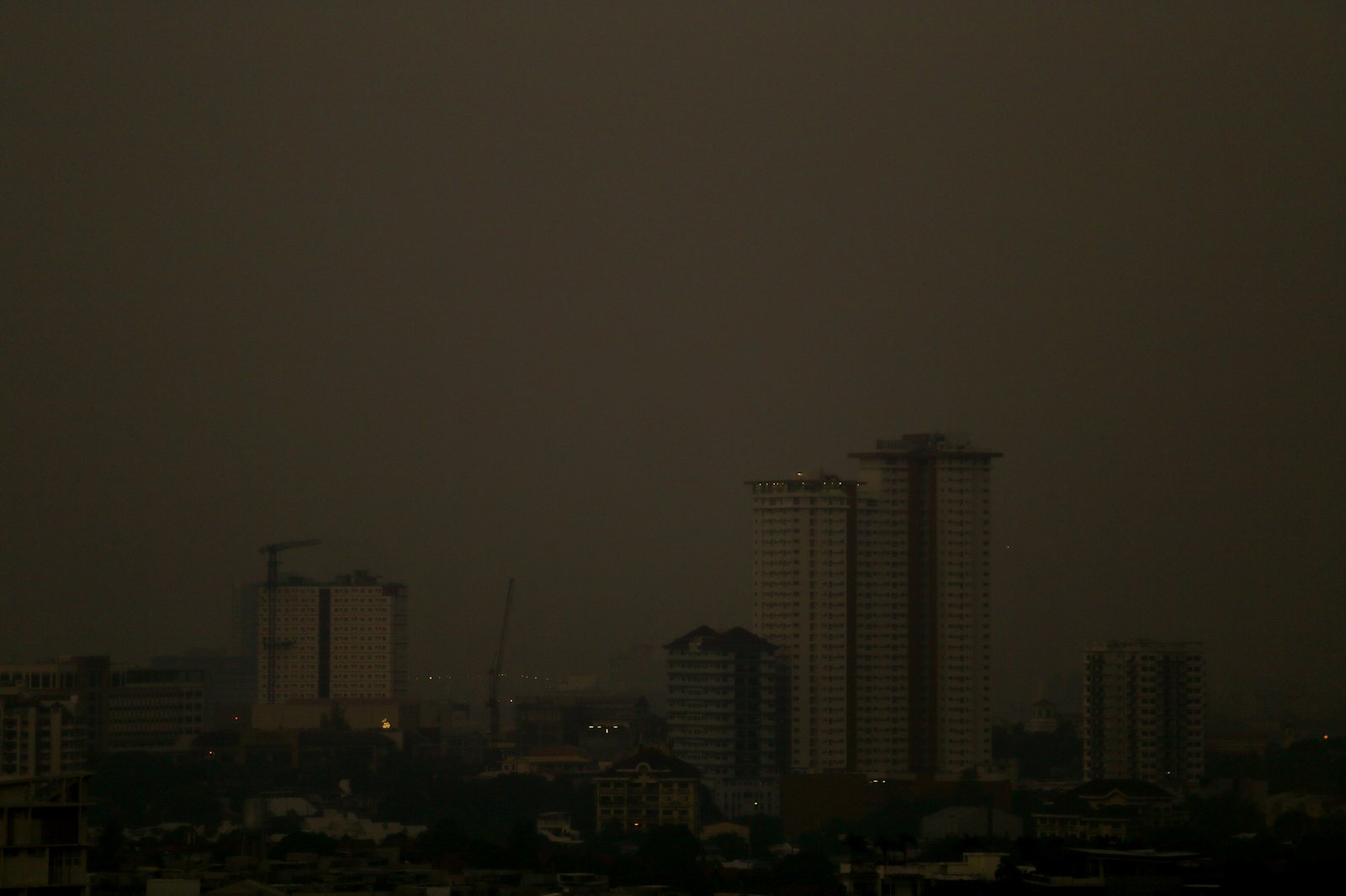 A thick haze blankets the Metro Manila skyline at 6:01am on 01 September 2026 as smoke from wildfires in Kalimantan is carried toward the Philippines by cross-equatorial winds. Air quality monitoring sensors across Metro Manila recorded AQI levels ranging from Unhealthy for Sensitive Groups to Very Unhealthy. Local government units, including Quezon City, have suspended face-to-face classes at all levels in public schools amid the poor air quality.