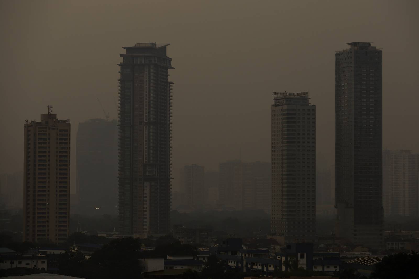 A thick haze blankets the Metro Manila skyline at 6:01am on 01 September 2026 as smoke from wildfires in Kalimantan is carried toward the Philippines by cross-equatorial winds. Air quality monitoring sensors across Metro Manila recorded AQI levels ranging from Unhealthy for Sensitive Groups to Very Unhealthy. Local government units, including Quezon City, have suspended face-to-face classes at all levels in public schools amid the poor air quality.