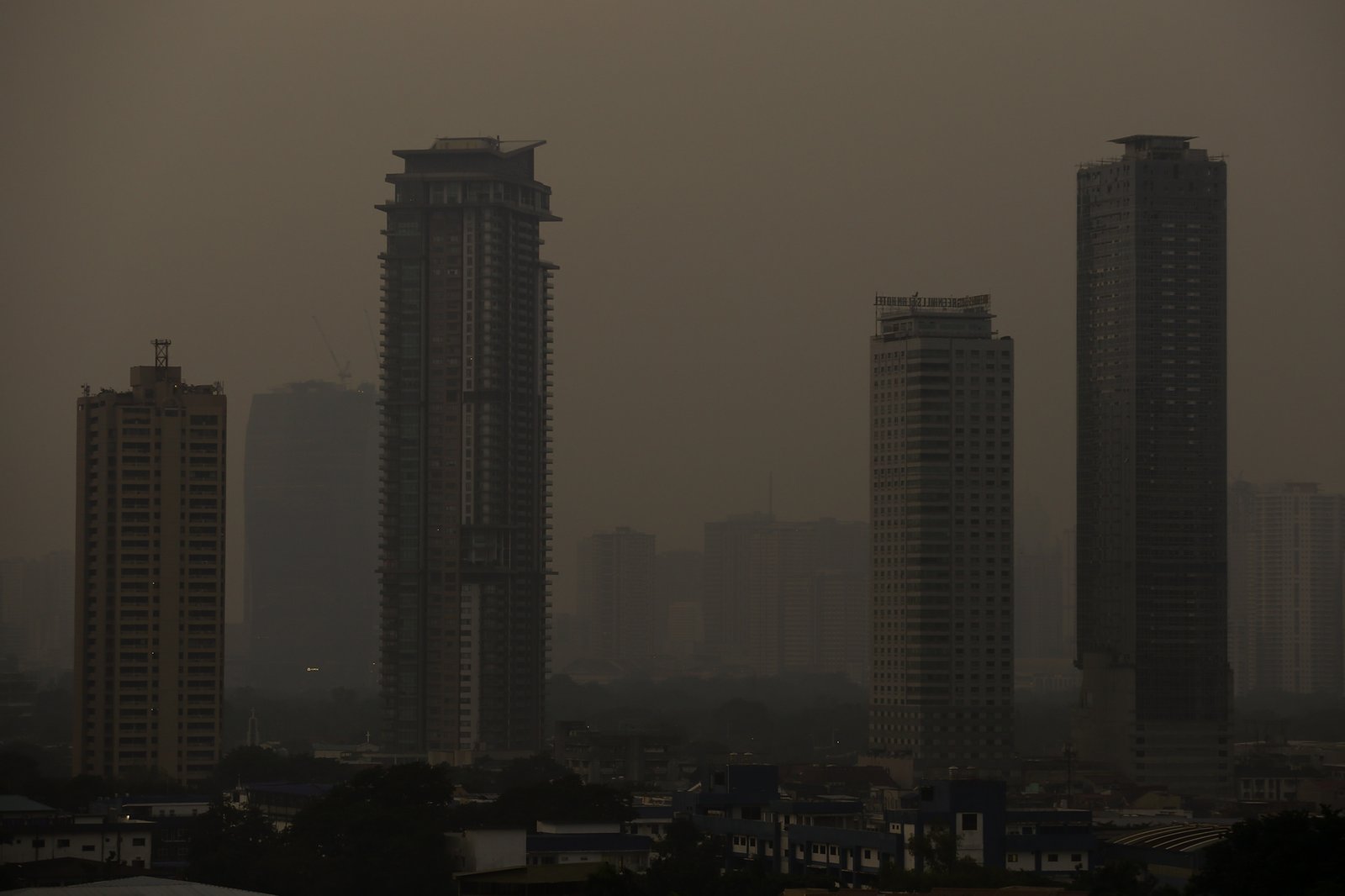 A thick haze blankets the Metro Manila skyline at 6:01am on 01 September 2026 as smoke from wildfires in Kalimantan is carried toward the Philippines by cross-equatorial winds. Air quality monitoring sensors across Metro Manila recorded AQI levels ranging from Unhealthy for Sensitive Groups to Very Unhealthy. Local government units, including Quezon City, have suspended face-to-face classes at all levels in public schools amid the poor air quality.