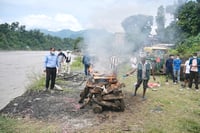 Morgues overflow, burials begin
